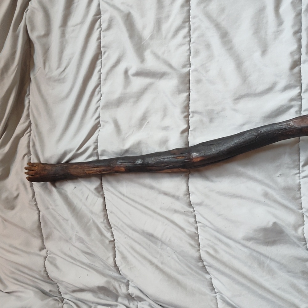 HandmadeMaterials: walking stick with a foot carved on one end.